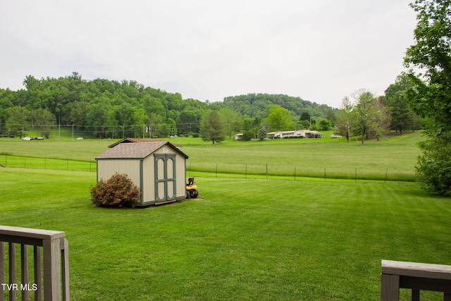 519 Foxgate Dr, Erwin, TN 37650 - view of yard with a storage unit, an outbuilding, a view of countryside, and a forest view