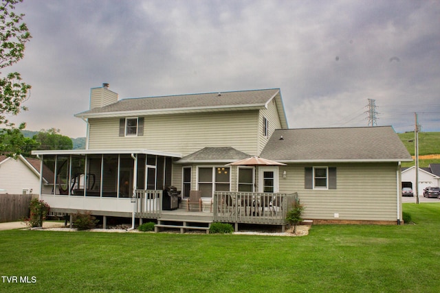 519 Foxgate Dr, Erwin, TN 37650 - rear view of house with a sunroom, a chimney, a wooden deck, a lawn, and roof with shingles