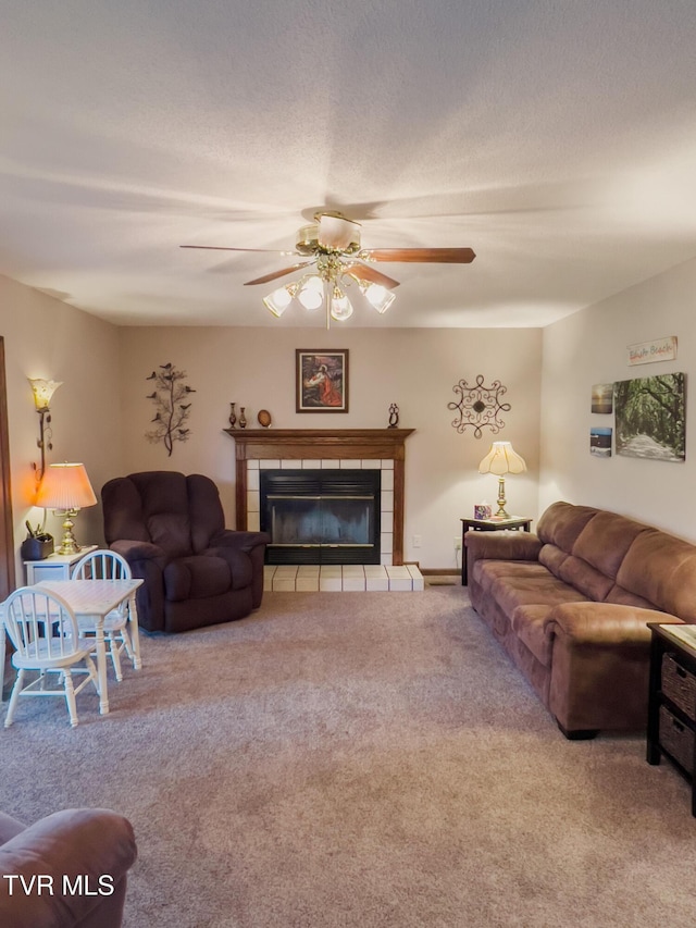 519 Foxgate Dr, Erwin, TN 37650 - carpeted living room with ceiling fan and a tiled fireplace