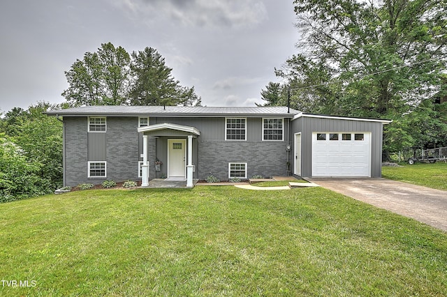 145 Elm Heights St, Johnson City, TN 37615 - bi-level home featuring an attached garage, concrete driveway, a front lawn, metal roof, and brick siding