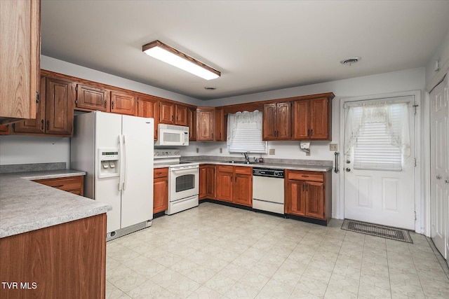 1544 Jessee St Unit Y, Kingsport, TN 37664 - kitchen with white appliances, a sink, light countertops, light floors, and brown cabinets