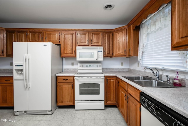 1544 Jessee St Unit Y, Kingsport, TN 37664 - kitchen with white appliances, a sink, light countertops, and brown cabinets