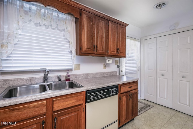 1544 Jessee St Unit Y, Kingsport, TN 37664 - kitchen with white dishwasher, a sink, light countertops, and brown cabinets