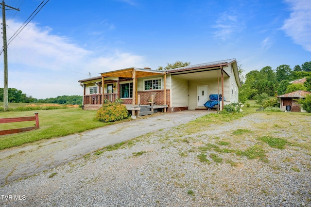 7175 Reedy Creek Rd, Bristol, VA 24202 - view of front facade featuring asphalt driveway, brick siding, a front lawn, and an attached carport