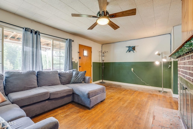 7175 Reedy Creek Rd, Bristol, VA 24202 - living area with light wood-style flooring, ceiling fan, and a brick fireplace