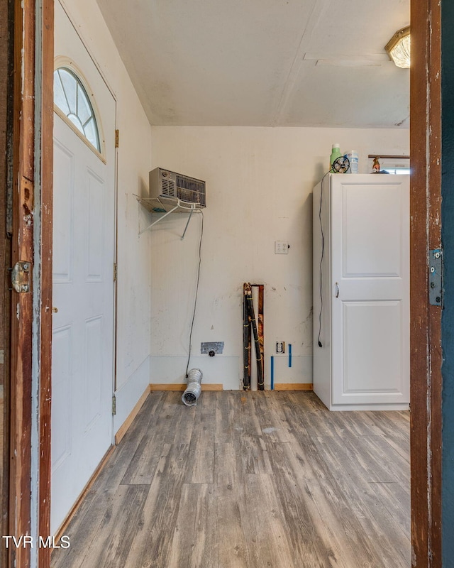 7175 Reedy Creek Rd, Bristol, VA 24202 - laundry area with wood finished floors, an AC wall unit, and baseboards