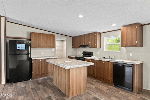 113 Hicks Dr, Johnson City, TN 37615 - kitchen featuring black appliances, under cabinet range hood, dark wood finished floors, light countertops, and a textured ceiling