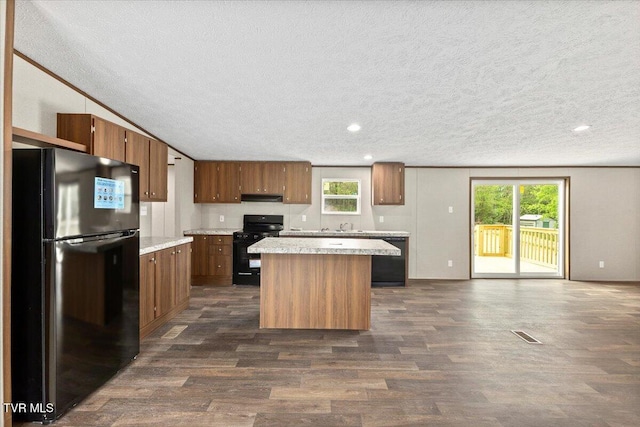 113 Hicks Dr, Johnson City, TN 37615 - kitchen featuring black appliances, light countertops, a textured ceiling, dark wood-style floors, and a kitchen island