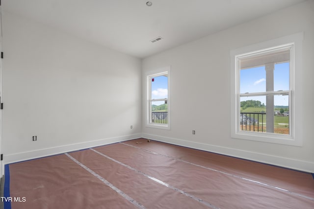 unfurnished room with baseboards
