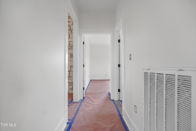 corridor with carpet and baseboards