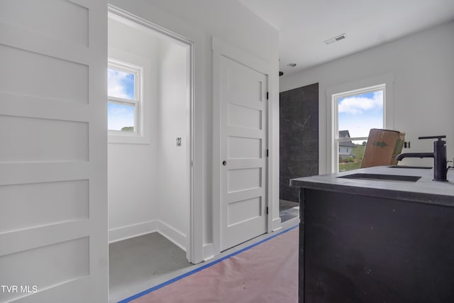 kitchen featuring healthy amount of natural light and baseboards