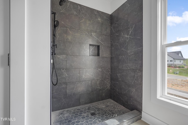 bathroom featuring a tile shower