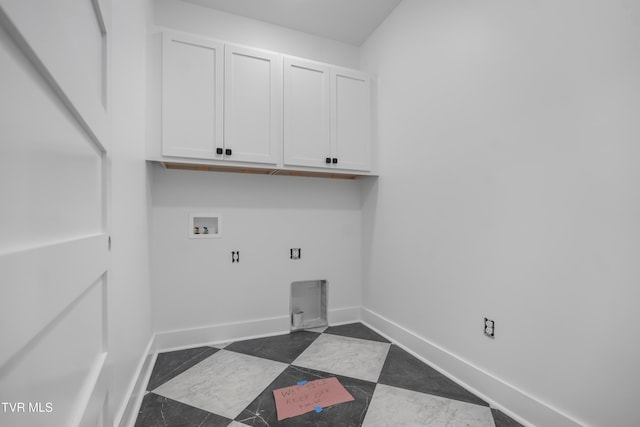 clothes washing area featuring cabinet space, washer hookup, baseboards, and electric dryer hookup