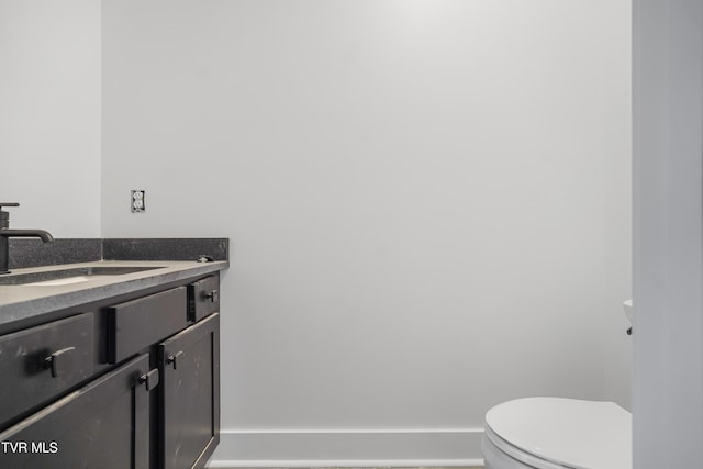 half bath featuring toilet and vanity