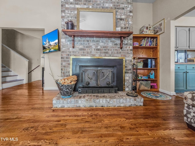 1382 Elijah Martin Rd, Whitesburg, TN 37891 - living room with wood finished floors, a brick fireplace, stairs, and baseboards