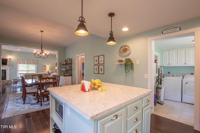 435 Sulpher Spring Rd, Chilhowie, VA 24319 - kitchen with washing machine and clothes dryer, dark wood-style floors, light countertops, a center island, and recessed lighting