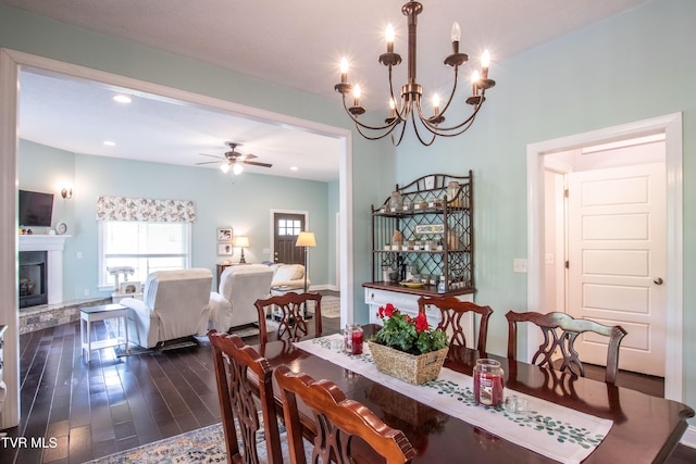 435 Sulpher Spring Rd, Chilhowie, VA 24319 - dining area featuring dark wood finished floors, a ceiling fan, a fireplace with raised hearth, a chandelier, and recessed lighting