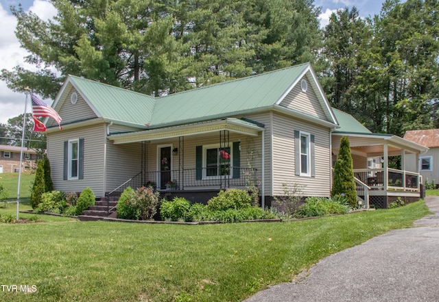 435 Sulpher Spring Rd, Chilhowie, VA 24319 - view of front facade featuring covered porch, a front yard, and metal roof