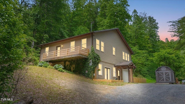 108 Chock Creek Rd, Johnson City, TN 37601 - view of front of house featuring driveway, a storage shed, an outdoor structure, a garage, and a deck