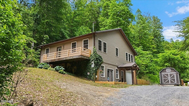 108 Chock Creek Rd, Johnson City, TN 37601 - view of front of home featuring an outbuilding, a storage unit, an attached garage, a deck, and gravel driveway