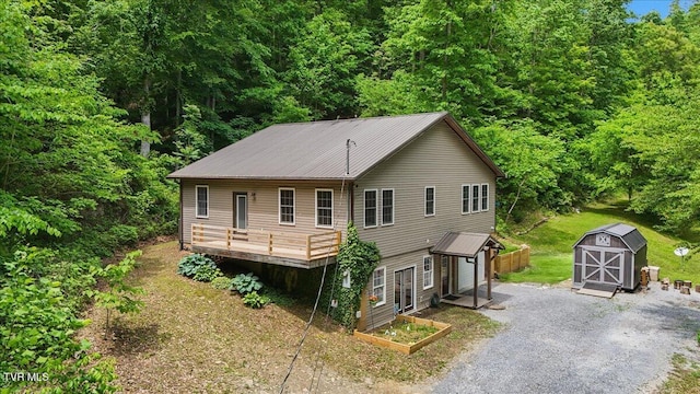 108 Chock Creek Rd, Johnson City, TN 37601 - view of front of home with a storage shed, an outbuilding, metal roof, a wooden deck, and a view of trees
