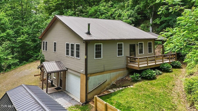 108 Chock Creek Rd, Johnson City, TN 37601 - rear view of property with an attached garage, a deck, metal roof, driveway, and a forest view