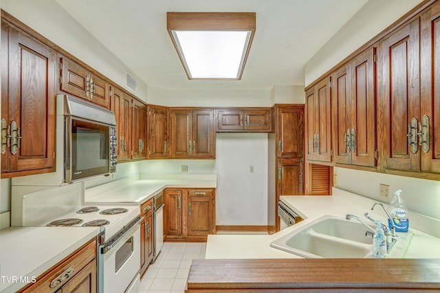 153 Columbine Rd, Kingsport, TN 37660 - kitchen with white electric stove, stainless steel microwave, a sink, light tile patterned flooring, and light countertops