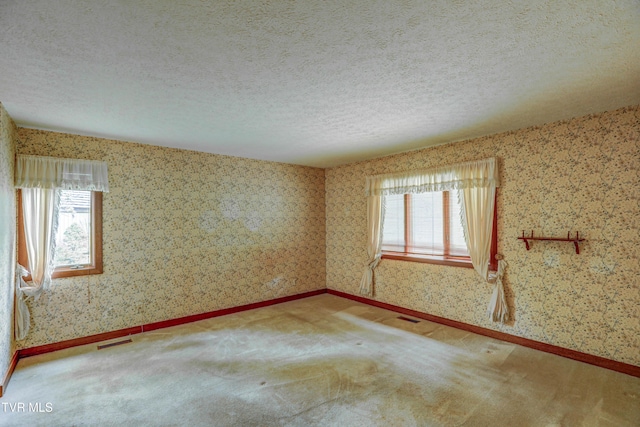 153 Columbine Rd, Kingsport, TN 37660 - carpeted spare room featuring healthy amount of natural light, wallpapered walls, a textured ceiling, and baseboards