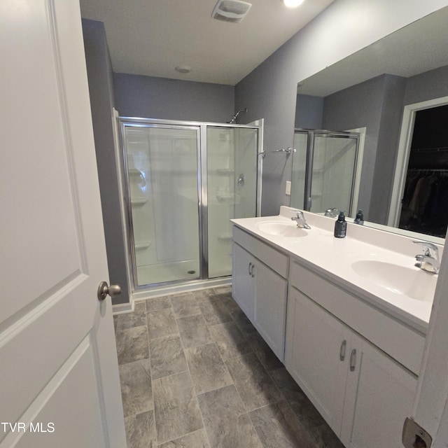 2358 Stream View Ln, Morristown, TN 37814 - full bathroom featuring a shower stall, double vanity, a walk in closet, and stone finish flooring