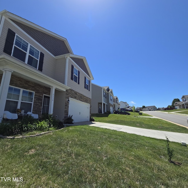2358 Stream View Ln, Morristown, TN 37814 - view of side of home featuring a residential view, a yard, a garage, driveway, and stone siding