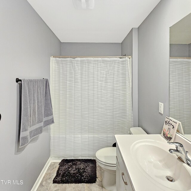 2358 Stream View Ln, Morristown, TN 37814 - bathroom with toilet, vanity, baseboards, and curtained shower