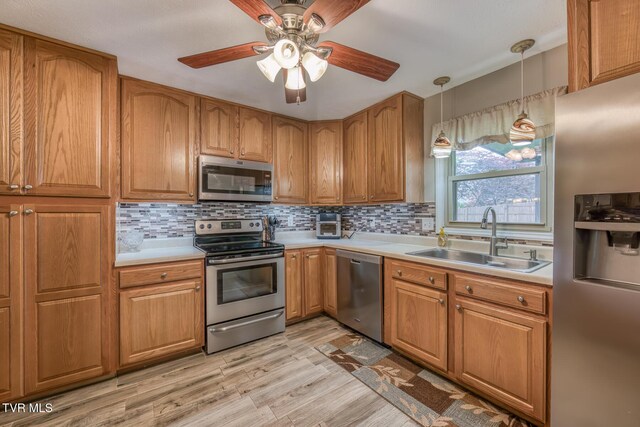 115 Dover Ln, Bristol, TN 37620 - kitchen with stainless steel appliances, a sink, brown cabinets, and light countertops