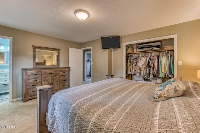 115 Dover Ln, Bristol, TN 37620 - bedroom with a closet, light carpet, a textured ceiling, and connected bathroom