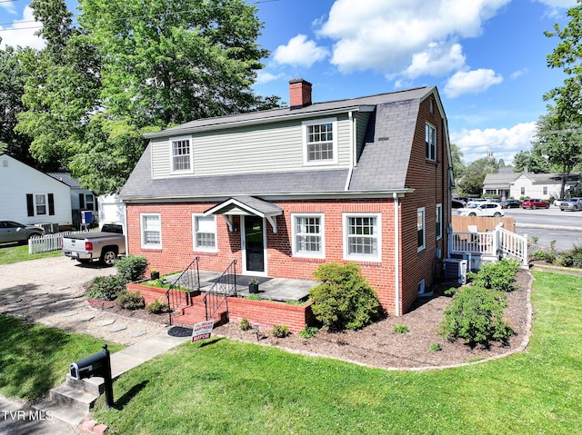 108 S Rogers St, Rogersville, TN 37857 - colonial inspired home featuring brick siding, central air condition unit, a chimney, a gambrel roof, and a shingled roof