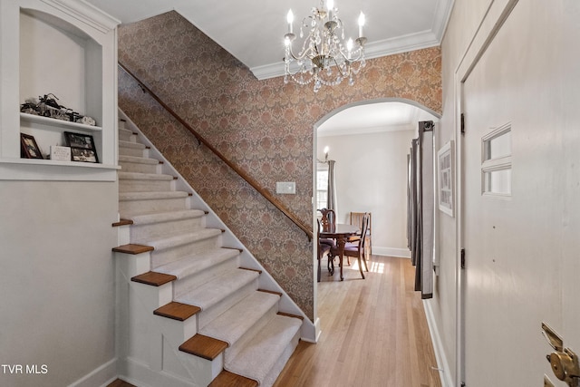 108 S Rogers St, Rogersville, TN 37857 - staircase with arched walkways, wallpapered walls, ornamental molding, wood finished floors, and baseboards