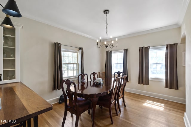 108 S Rogers St, Rogersville, TN 37857 - dining area featuring a chandelier, light wood-type flooring, crown molding, and baseboards