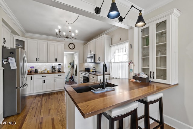 108 S Rogers St, Rogersville, TN 37857 - kitchen featuring stainless steel appliances, wood counters, a sink, white cabinets, and tasteful backsplash