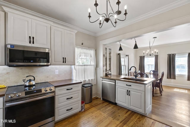 108 S Rogers St, Rogersville, TN 37857 - kitchen with appliances with stainless steel finishes, a chandelier, a sink, a peninsula, and light wood-style flooring