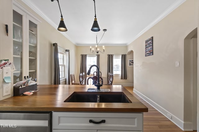 108 S Rogers St, Rogersville, TN 37857 - kitchen with arched walkways, a sink, stainless steel dishwasher, crown molding, and a chandelier