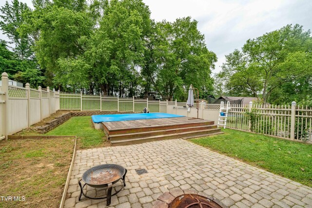 137 Highland Rd, Jonesborough, TN 37659 - view of patio featuring a fire pit, a deck, and view of wooded area