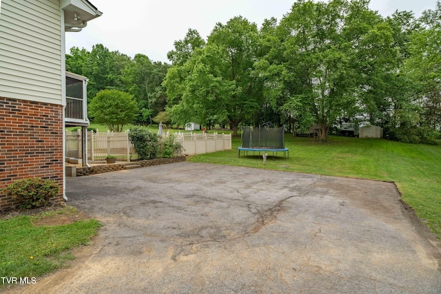 137 Highland Rd, Jonesborough, TN 37659 - view of patio featuring a trampoline, a storage shed, and an outbuilding