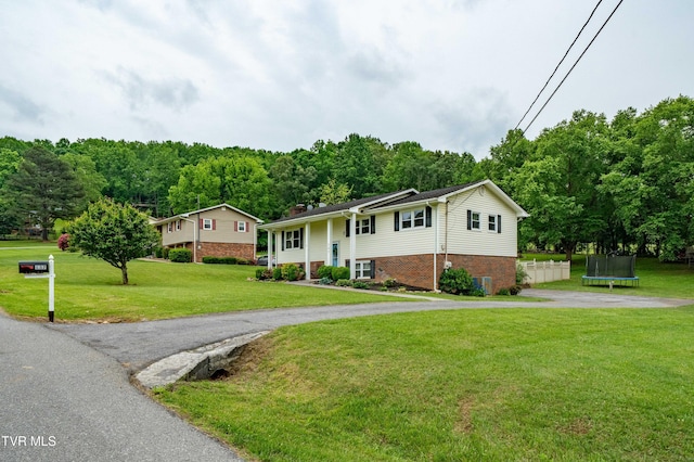 137 Highland Rd, Jonesborough, TN 37659 - split foyer home with a trampoline, driveway, a front yard, central air condition unit, and a wooded view