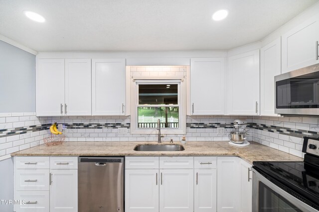 137 Highland Rd, Jonesborough, TN 37659 - kitchen with appliances with stainless steel finishes, a sink, decorative backsplash, white cabinets, and recessed lighting