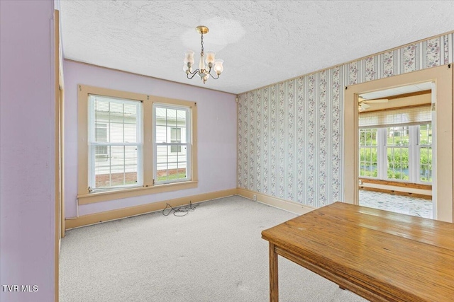 648 Maple Ave, Erwin, TN 37650 - unfurnished dining area with a chandelier, carpet floors, baseboards, a textured ceiling, and healthy amount of natural light