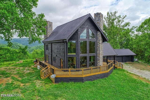 833 Duck Creek Rd, Sneedville, TN 37869 - rear view of house featuring a chimney, a standing seam roof, and a wooden deck