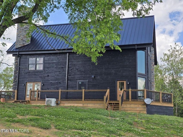 833 Duck Creek Rd, Sneedville, TN 37869 - rear view of house featuring a standing seam roof, a deck, metal roof, a chimney, and a lawn