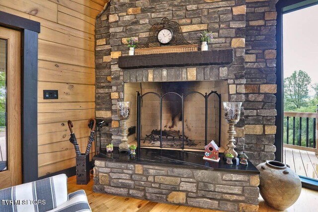 833 Duck Creek Rd, Sneedville, TN 37869 - detailed view of wood finished floors, wood walls, and a fireplace