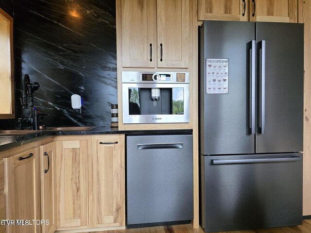 833 Duck Creek Rd, Sneedville, TN 37869 - kitchen with appliances with stainless steel finishes, dark countertops, decorative backsplash, a sink, and light brown cabinetry
