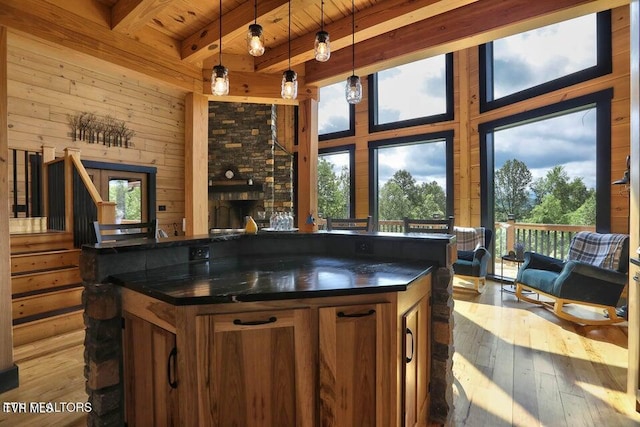 833 Duck Creek Rd, Sneedville, TN 37869 - kitchen featuring dark countertops, open floor plan, brown cabinetry, wooden ceiling, and beam ceiling