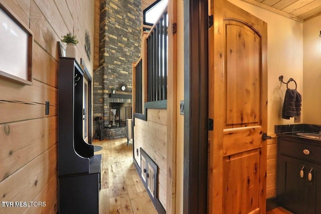 833 Duck Creek Rd, Sneedville, TN 37869 - hall with light wood-type flooring, wooden ceiling, and wood walls